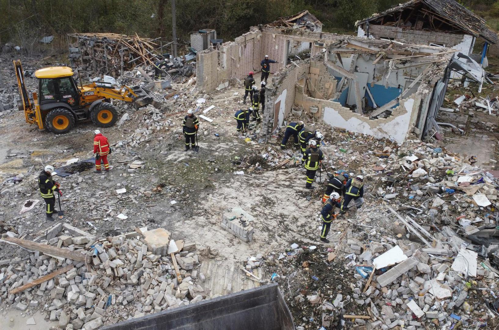 Rescues remove debris at a site of buildings of a local cafe and a grocery store, where at least 52 people were killed by a Russian missile strike, amid Russia's attack on Ukraine, in the village of Hroza, in Kharkiv region, Ukraine October 6, 2023. REUTERS/Yan Dobronosov Photo: STRINGER/REUTERS