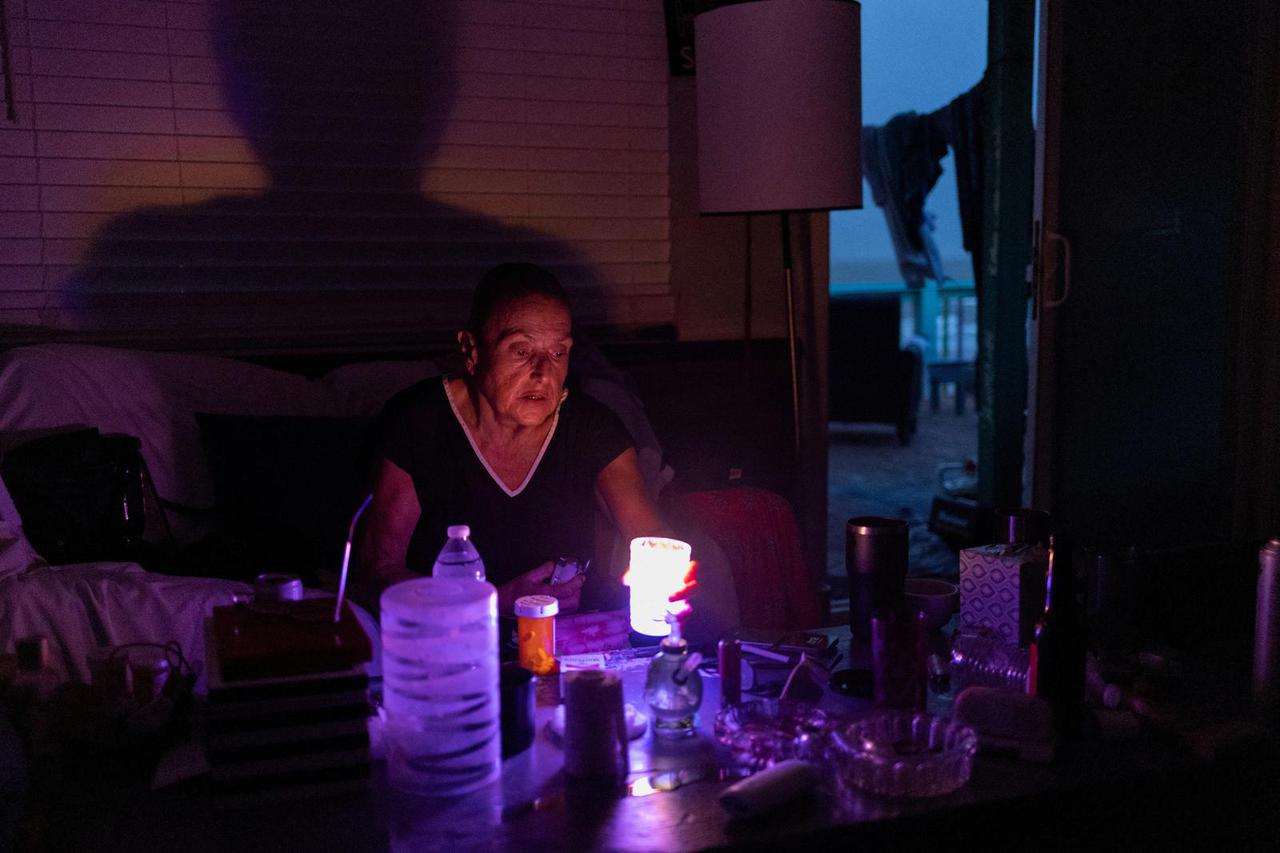 FILE PHOTO: Resident lights candles after losing electricity due to Hurricane Beryl in Surfside Beach, Texas