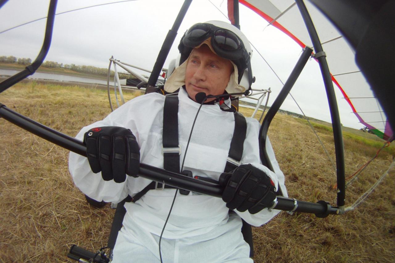 'Russian President Vladimir Putin sits in a motorised deltaplane at Yamalo-Nenets district September 5, 2012. Putin, who has tracked a Siberian tiger and posed with a polar bear, on Wednesday took his