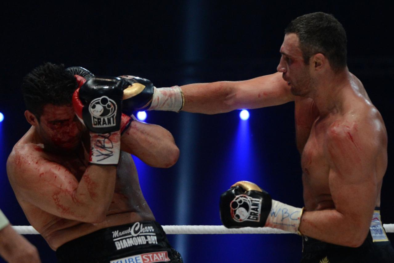 'Ukraine\'s two-time World Heavyweight champion Vitali Klitschko (R) fights for the defense his WBC heavyweight title against Germany\'s Manuel Charr in Moscow early on September 9, 2012. AFP PHOTO / 