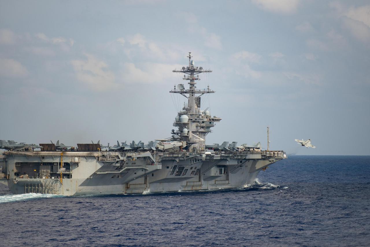 An F/A-18F Super Hornet launches from the flight deck of the U.S. Navy aircraft carrier USS Theodore Roosevelt in the Philippine Sea