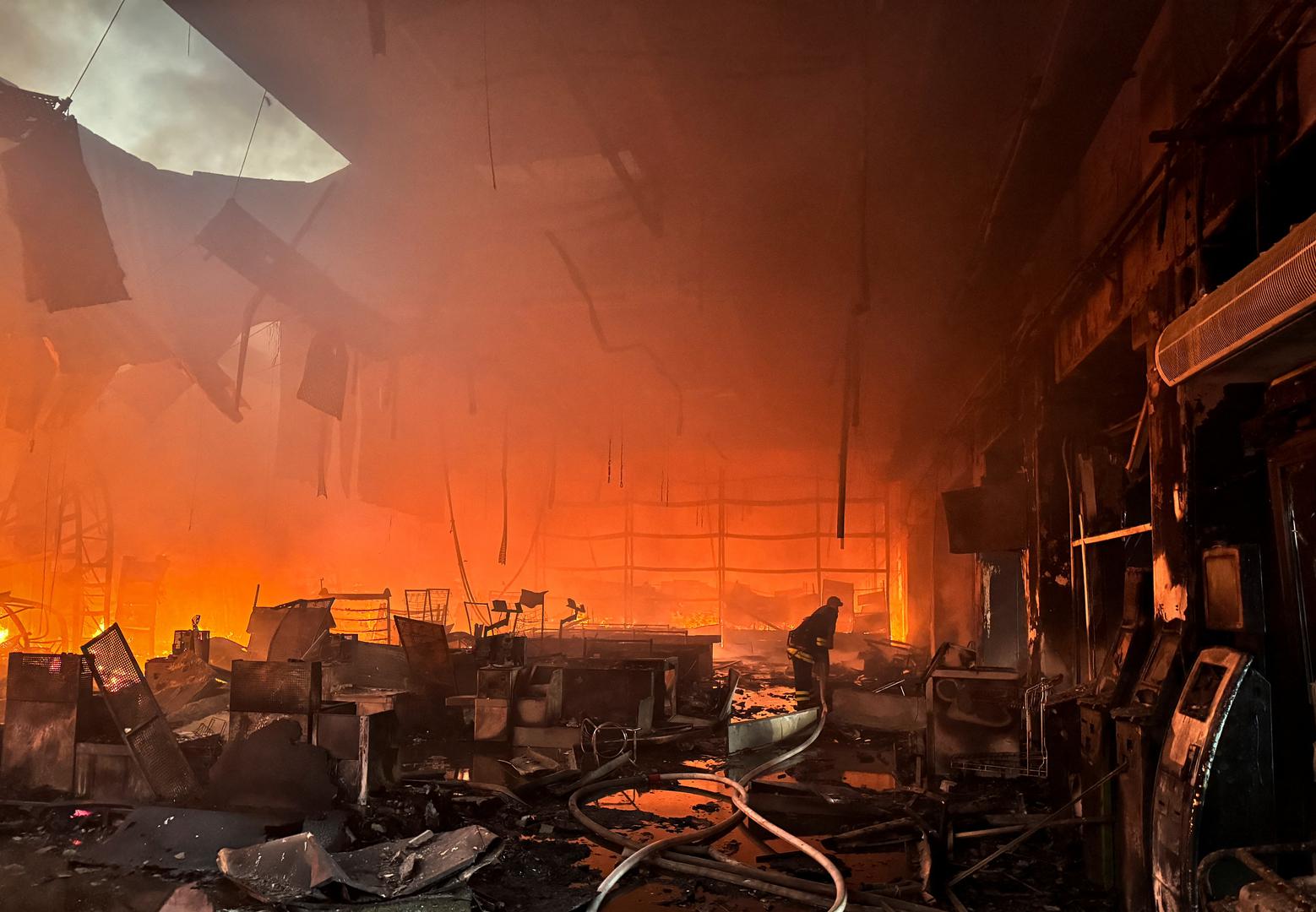 Firefighters work at a site of a household item shopping mall hit by a Russian air strike, amid Russia's attack on Ukraine, in Kharkiv, Ukraine May 25, 2024. REUTERS/Vitalii Hnidyi Photo: Vitalii Hnidyi/REUTERS