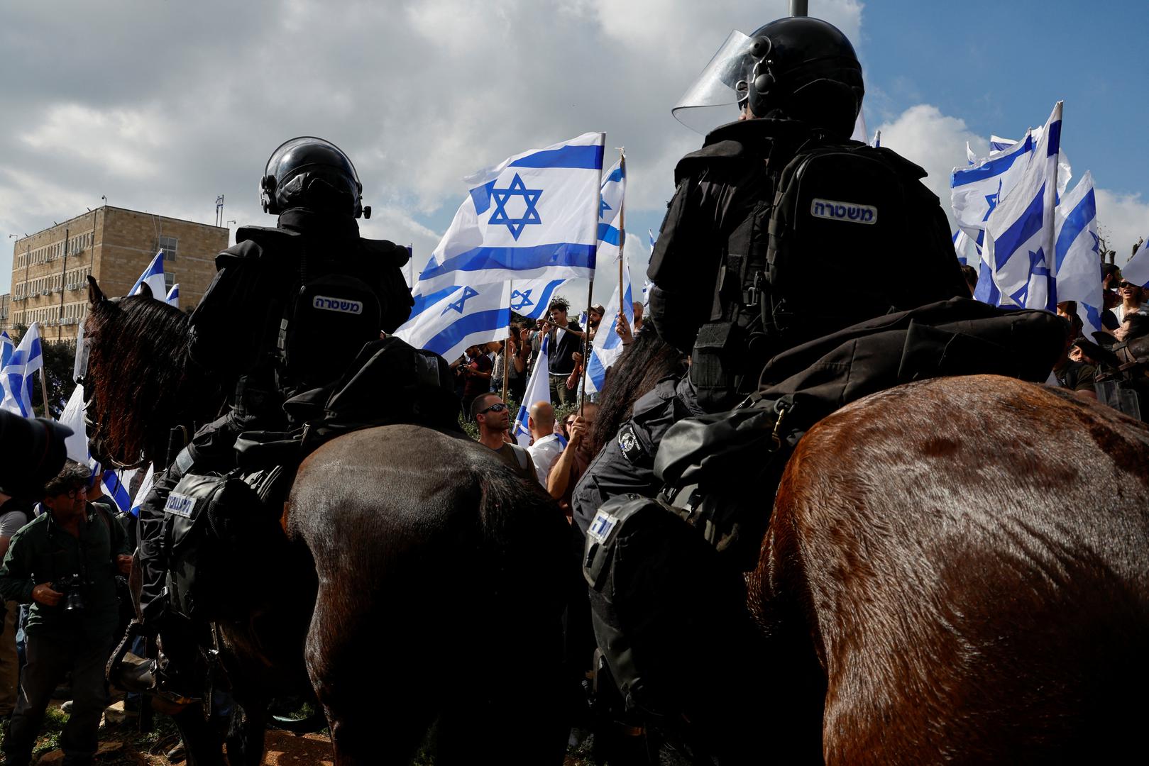 People attend a demonstration after Israeli Prime Minister Benjamin Netanyahu dismissed the defense minister as his nationalist coalition government presses on with its judicial overhaul, in Jerusalem, March 27, 2023. REUTERS/Ammar Awad Photo: AMMAR AWAD/REUTERS