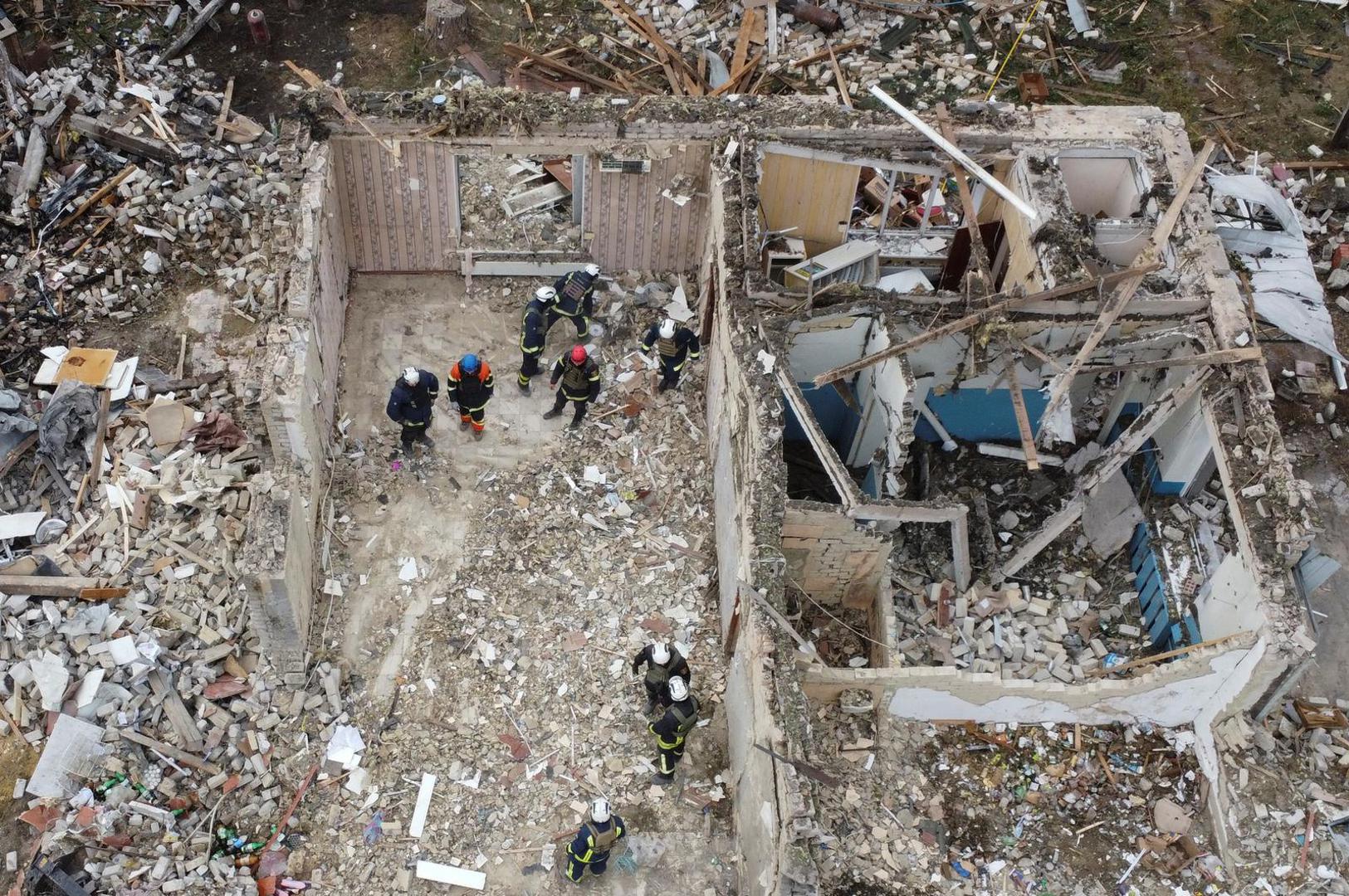 Rescues remove debris at a site of buildings of a local cafe and a grocery store, where at least 52 people were killed by a Russian missile strike, amid Russia's attack on Ukraine, in the village of Hroza, in Kharkiv region, Ukraine October 6, 2023. REUTERS/Yan Dobronosov Photo: Stringer/REUTERS