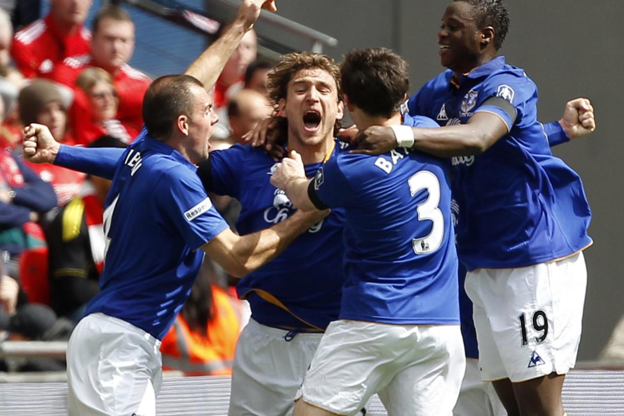 'Everton\'s Nikica Jelavic (2nd L) celebrates his goal against Liverpool with teammates during their FA Cup semi-final soccer match at Wembley Stadium in London April 14, 2012.   REUTERS/Darren Staple