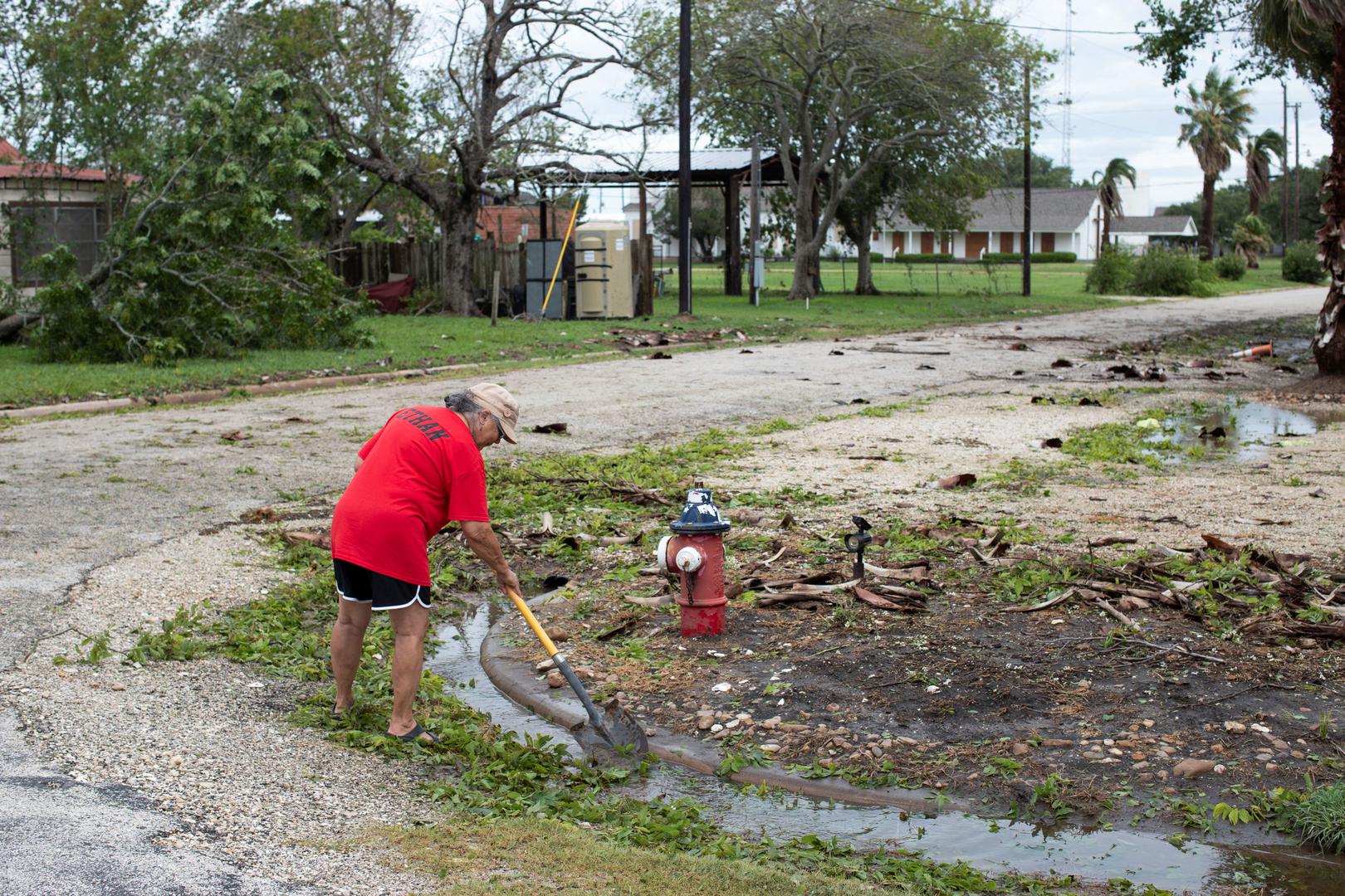 Marguerite Cruti clears debris from culverts to allow standing water to flow after Hurricane Beryl moved through the area in Matagorda, Texas, U.S. July 8, 2024.  REUTERS/Kaylee Greenlee Beal Photo: KAYLEE GREENLEE BEAL/REUTERS