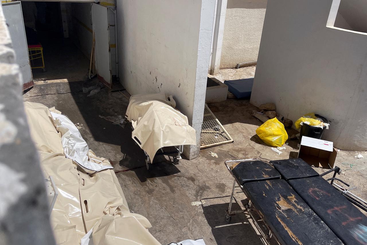 Dead bodies, lying in bags, are pictured at the entrance of Habib Bourguiba hospital morgue in Sfax