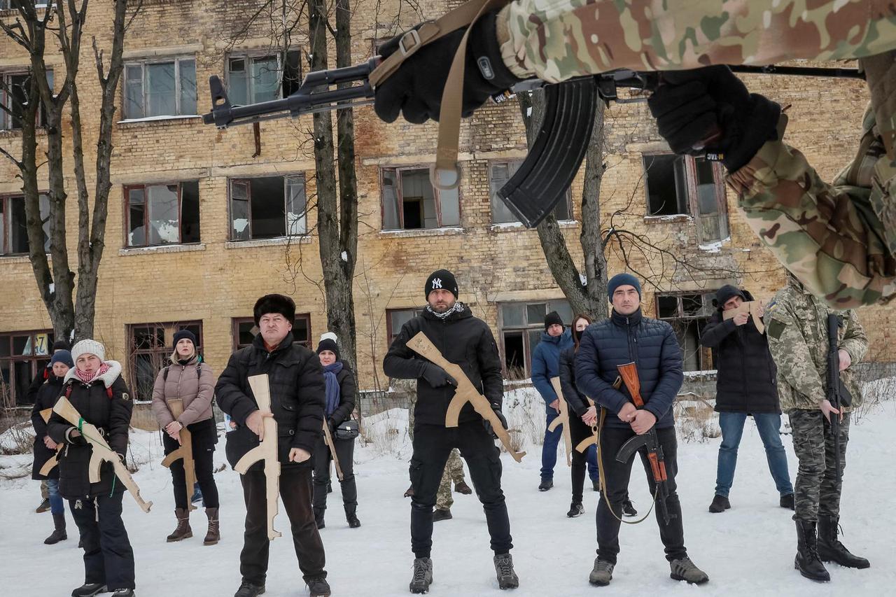 People take part in a military exercise for civilians conducted by veterans of the Ukrainian National Guard Azov battalion in Kyiv