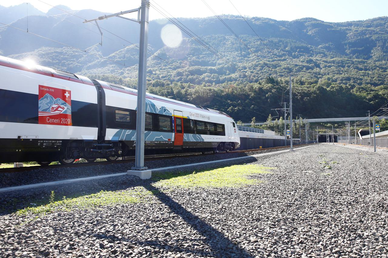 Train stands in front of the entrances of the newly built Ceneri Base Tunnel near Camorino