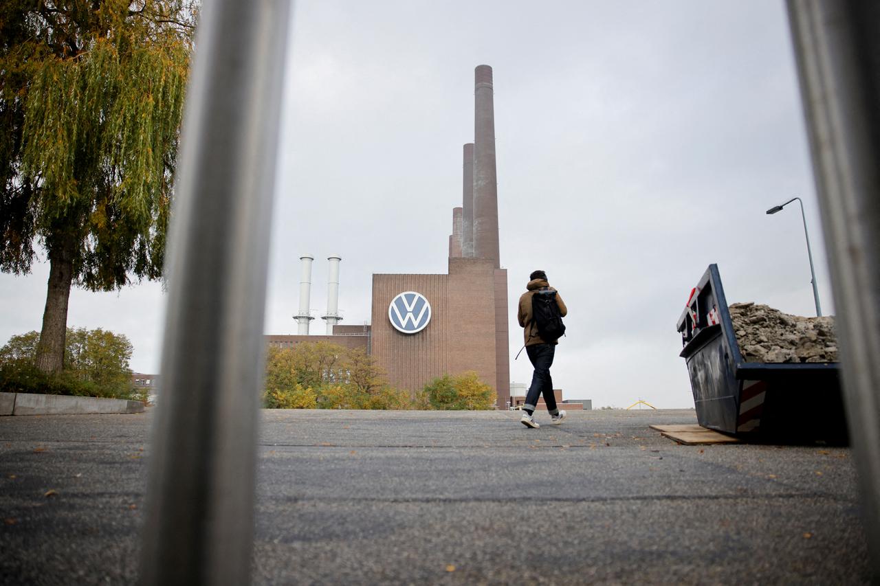 A man walks past a factory at Volkswagen AG headquarters, in Wolfsburg