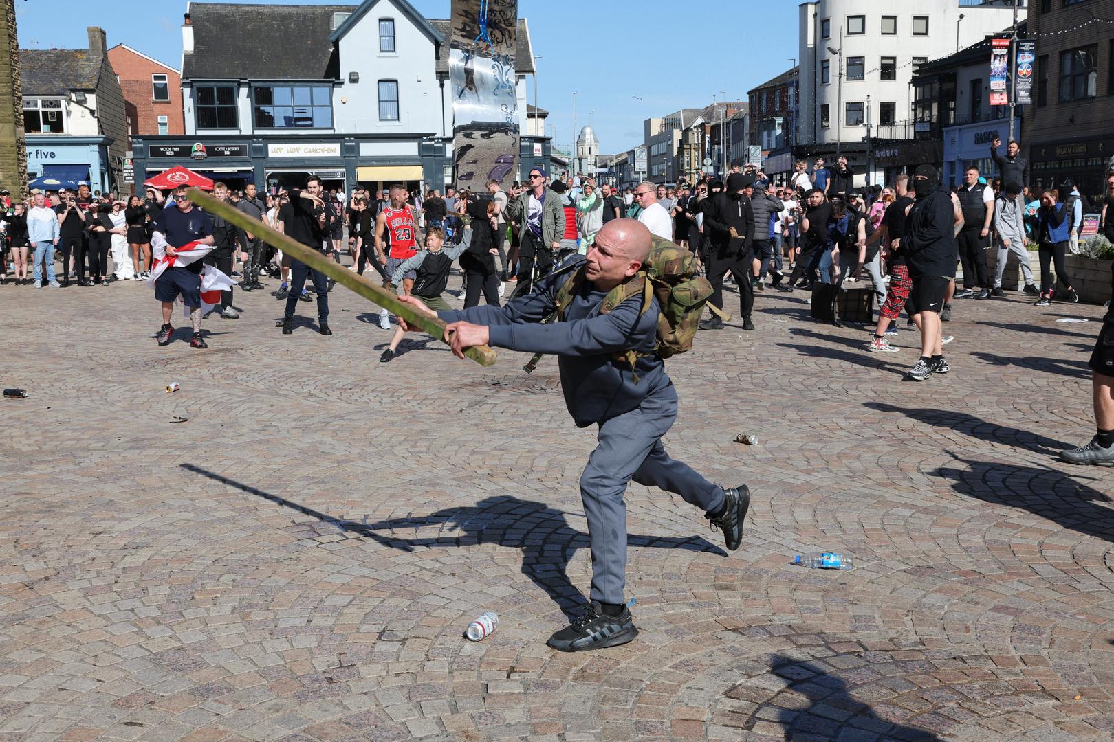 A man swings a length of wood as people protest in Blackpool, following the stabbing attacks on Monday in Southport, in which three young children were killed. Picture date: Saturday August 3, 2024. Photo: Michael Holmes/PRESS ASSOCIATION