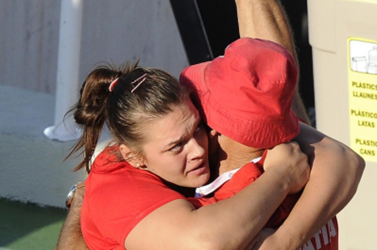 'Croatia\'s Sandra Perkovic (L)  celebrates her victory with her coach after the women\'s discus throw final at the 2010 European Athletics Championships at the Olympic Stadium in Barcelona on July 28