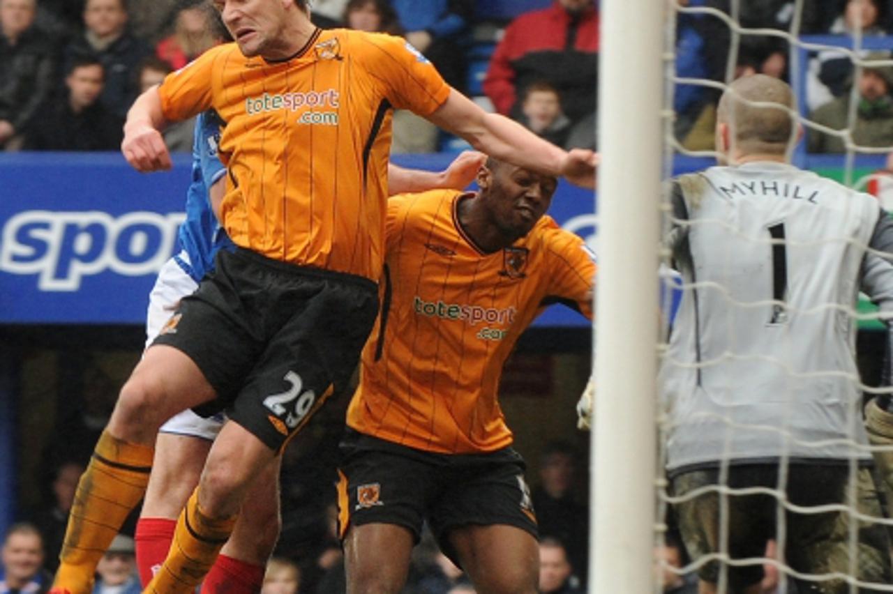 'Hull City\'s Dutch striker Jan Vennegoor of Hesselink (L) heads the ball clear during the English Premier League football match between Portsmouth and Hull City at Fratton Park in Portsmouth, souther