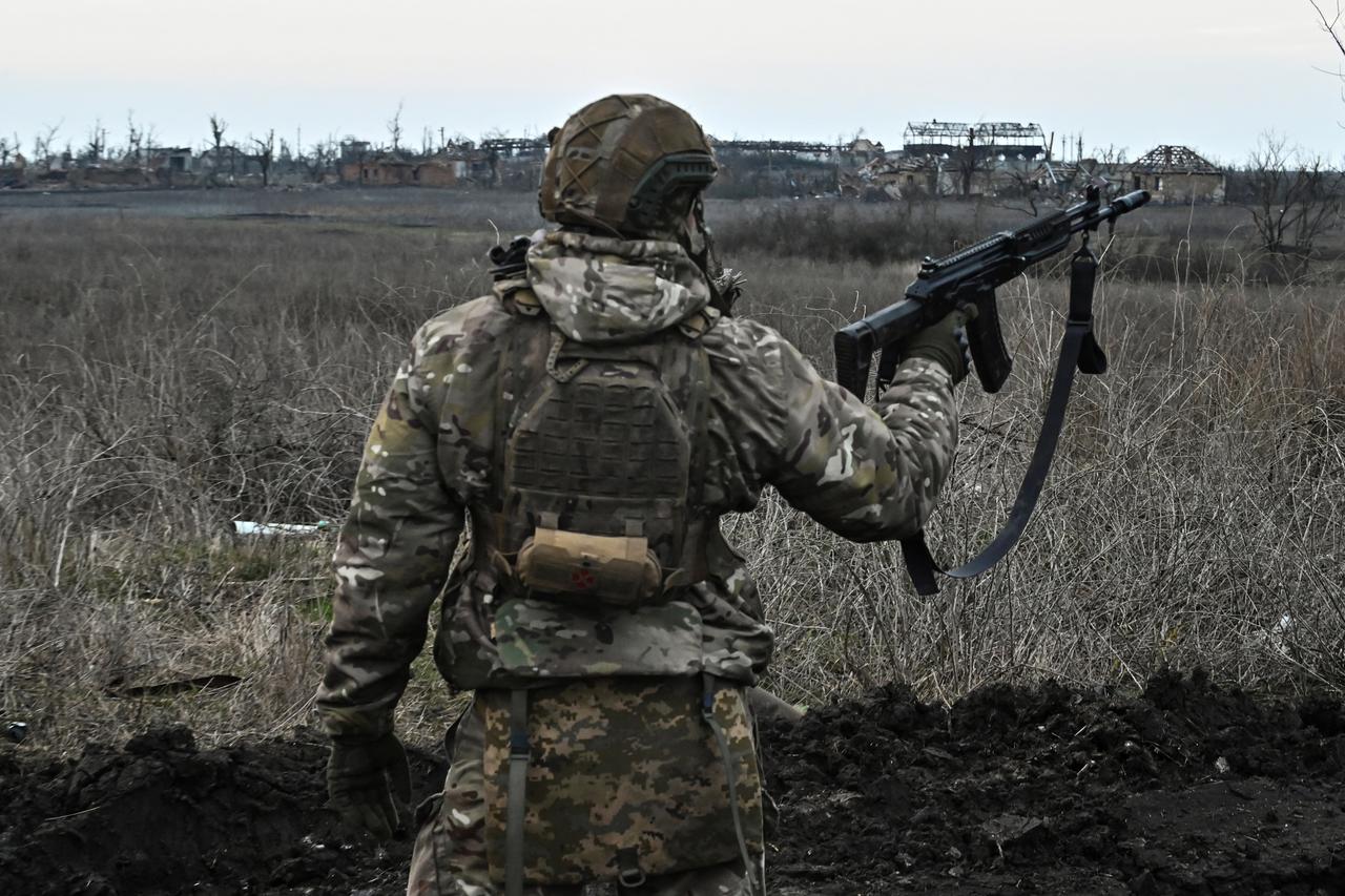Ukrainian serviceman looks at destroyed houses in the front line village of Robotyne in Zaporizhzhia region