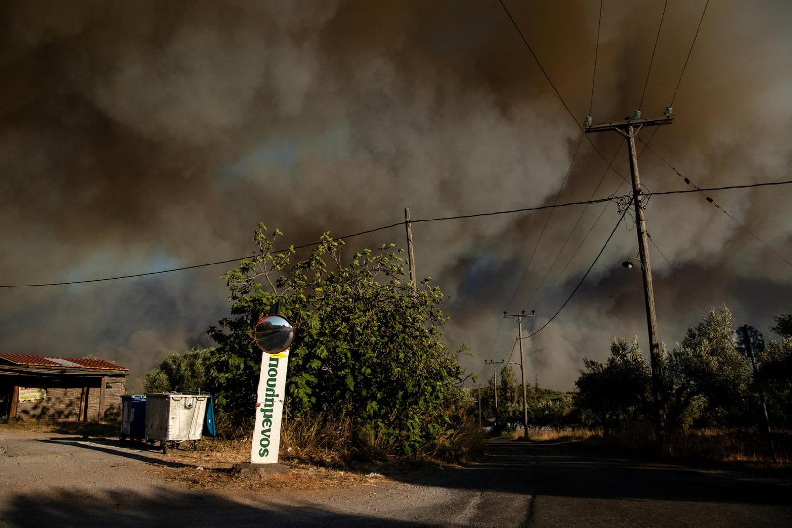 Smoke rises as a wildfire burns outside the village of Varnavas, near Athens, Greece, August 11, 2024. REUTERS/Hilary Swift Photo: Hilary Swift/REUTERS