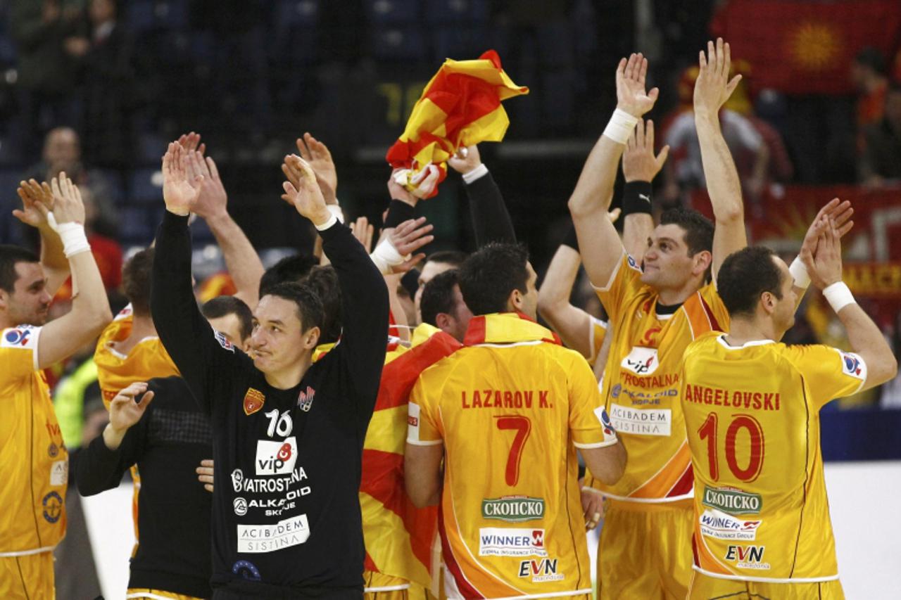 'Macedonia players celebrate defeating Serbia in their Men\'s European Handball Championship main round group 1 match in Belgrade January 25, 2012.                     REUTERS/Ivan Milutinovic (SERBIA