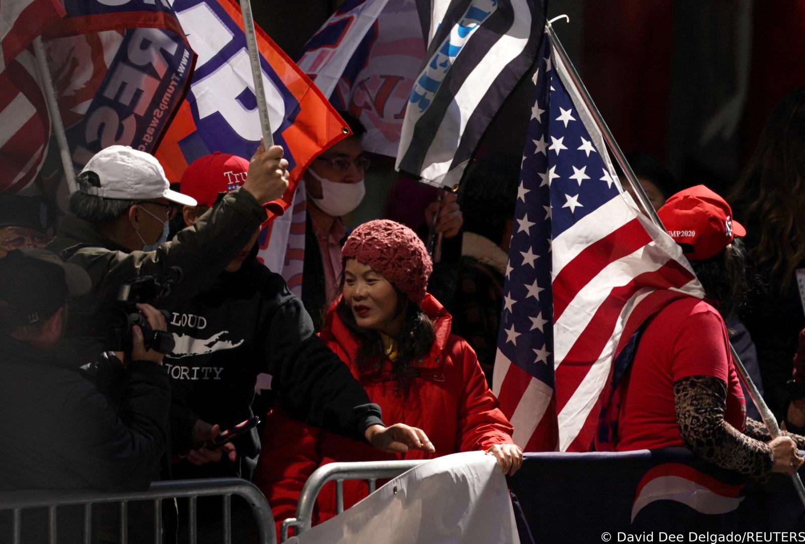 Supporters of former U.S. President Donald Trump hold flags, after Donald Trump's indictment by a Manhattan grand jury following a probe into hush money paid to porn star Stormy Daniels, in New York City, U.S, April 3, 2023.  REUTERS/David Dee Delgado Photo: David Dee Delgado/REUTERS