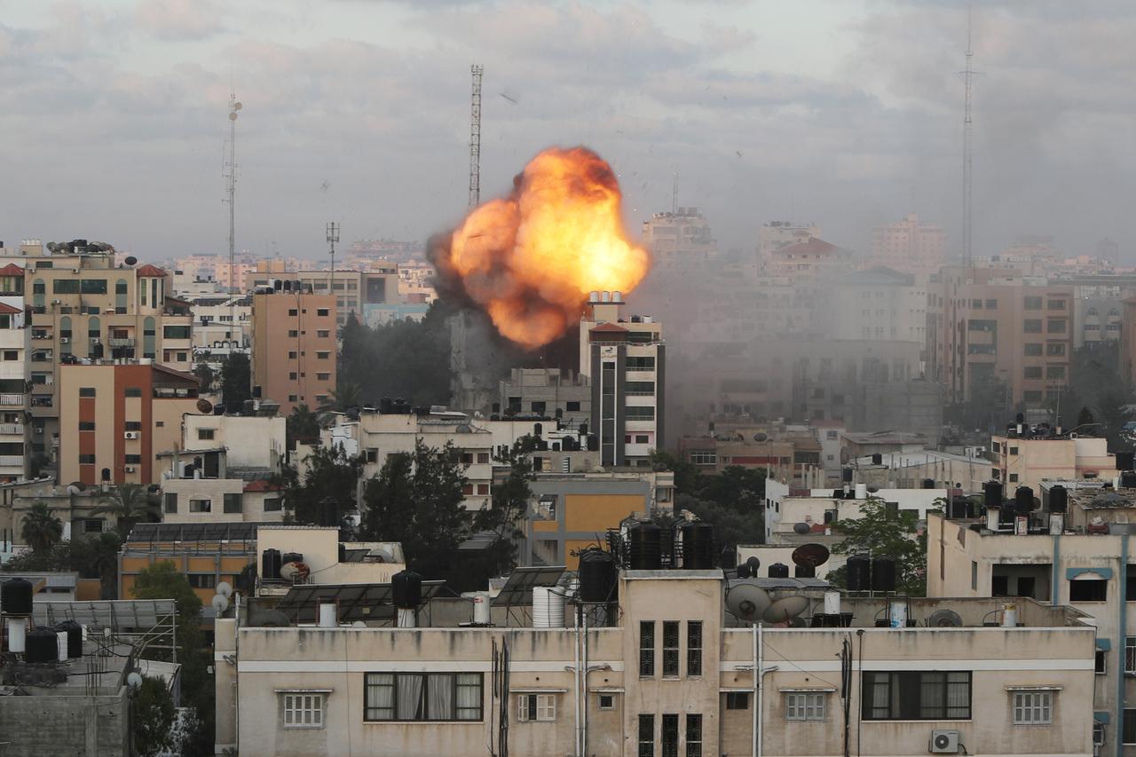 Smoke and flames are seen following an Israeli air strike on a building, amid a flare-up of Israeli-Palestinian fighting, in Gaza City