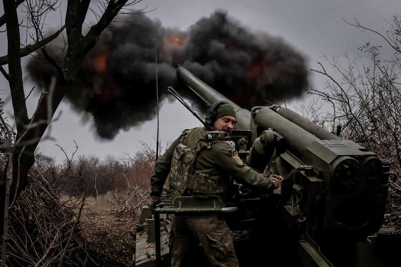 Ukrainian servicemen fire a self-propelled howitzer towards Russian troops at a front line near the town of Chasiv Yar