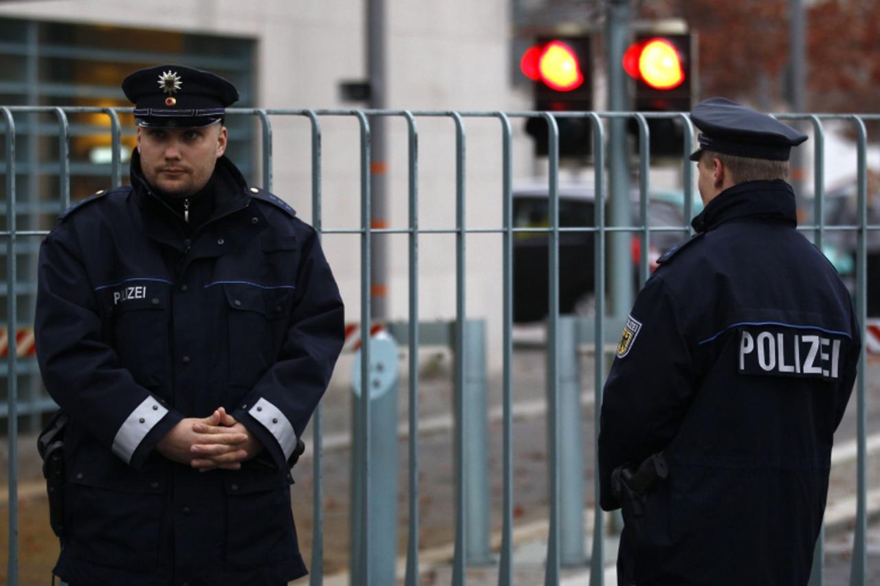 \'Policemen stand guard in front of the closed main gate of the Chancellery in Berlin, November 2, 2010. German police found a suspicious package in the post at Chancellor Angela Merkel\'s office in B