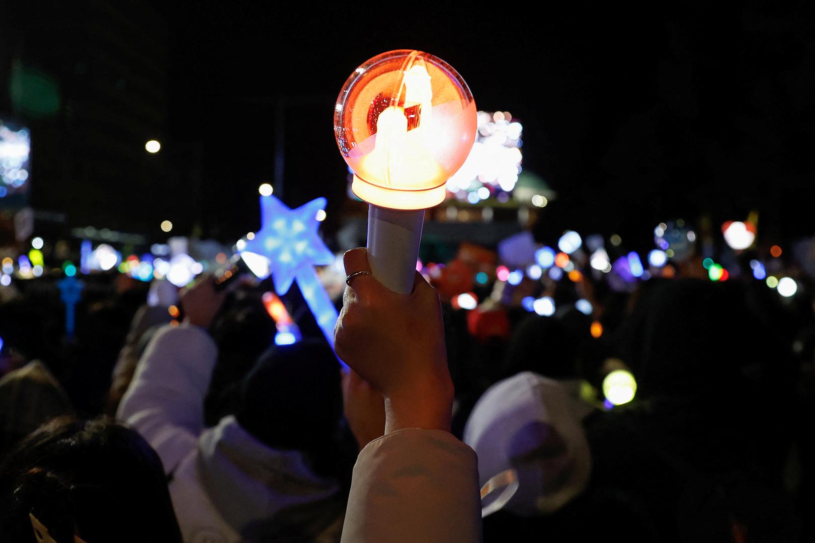 A protester holds up a K-pop idol stick, as protesters take part in a rally calling for the impeachment of South Korean President Yoon Suk Yeol, who declared martial law, which was reversed hours later, near the National Assembly in Seoul, South Korea, December 8, 2024. REUTERS/Kim Soo-hyeon Photo: KIM SOO-HYEON/REUTERS