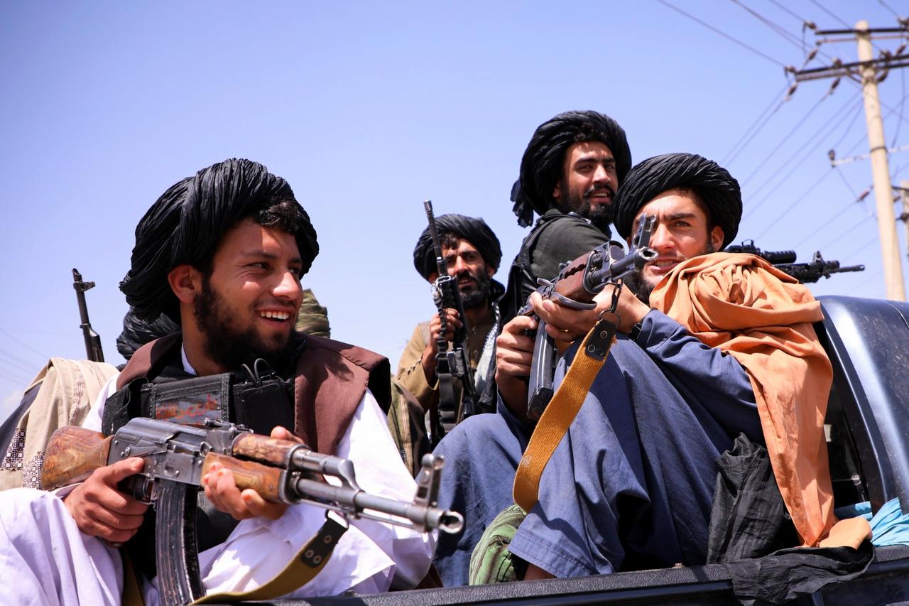 Taliban forces patrol in front of Hamid Karzai International Airport in Kabul