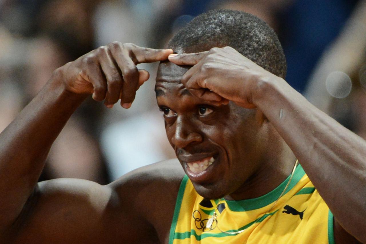 'Jamaica\'s Usain Bolt gestures prior to taking the start of the men\'s 100m final at the athletics event during the London 2012 Olympic Games on August 5, 2012 in London.    AFP PHOTO / FRANCK FIFE'