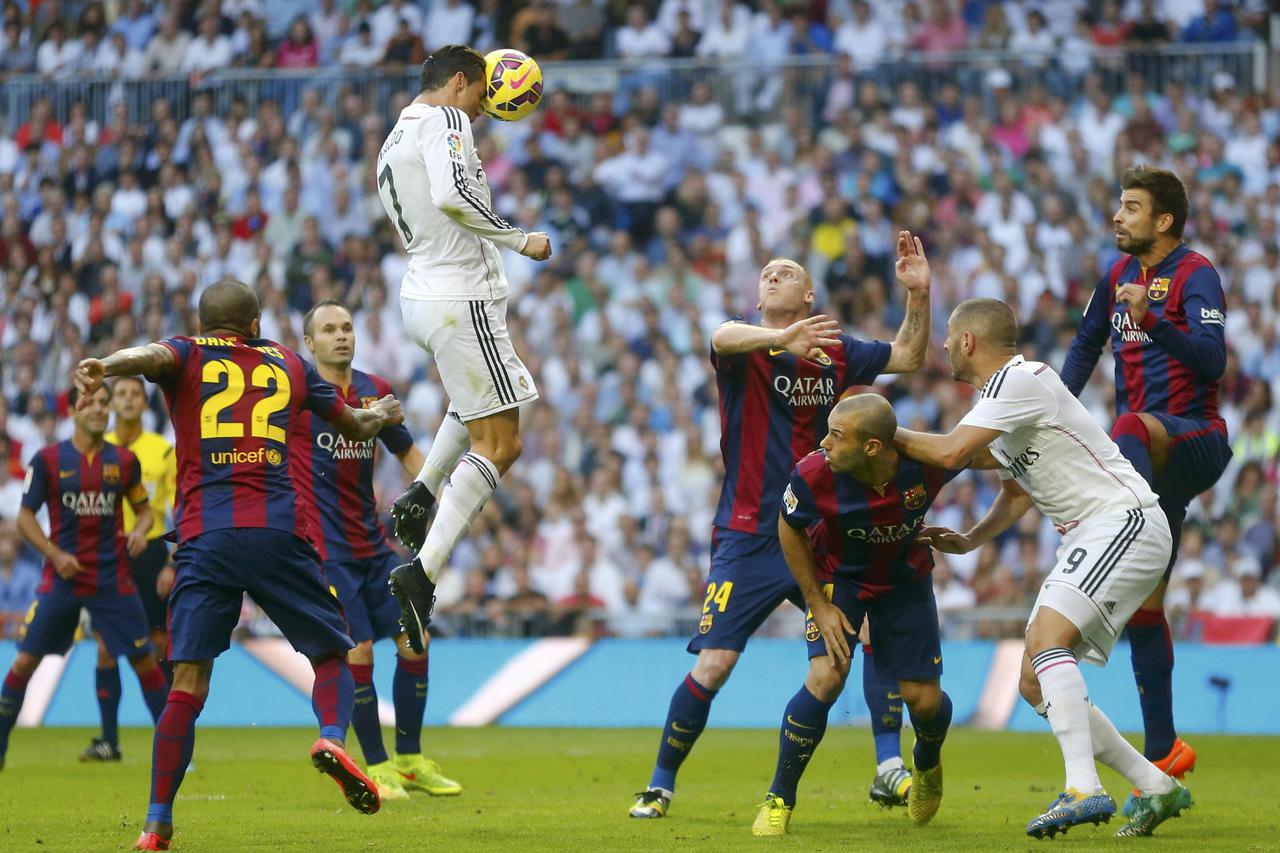 Real Madrid's Cristiano Ronaldo (top) heads the ball but fails to score against Barcelona during their Spanish first division 