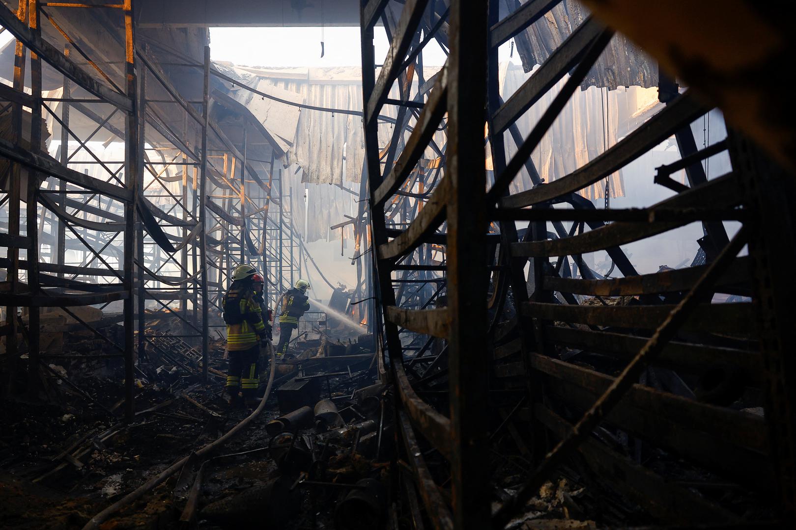 Firefighters work at the site of a household item shopping mall which was hit by a Russian air strike, amid Russia's attack on Ukraine, in Kharkiv, Ukraine, May 25, 2024. REUTERS/Valentyn Ogirenko Photo: VALENTYN OGIRENKO/REUTERS