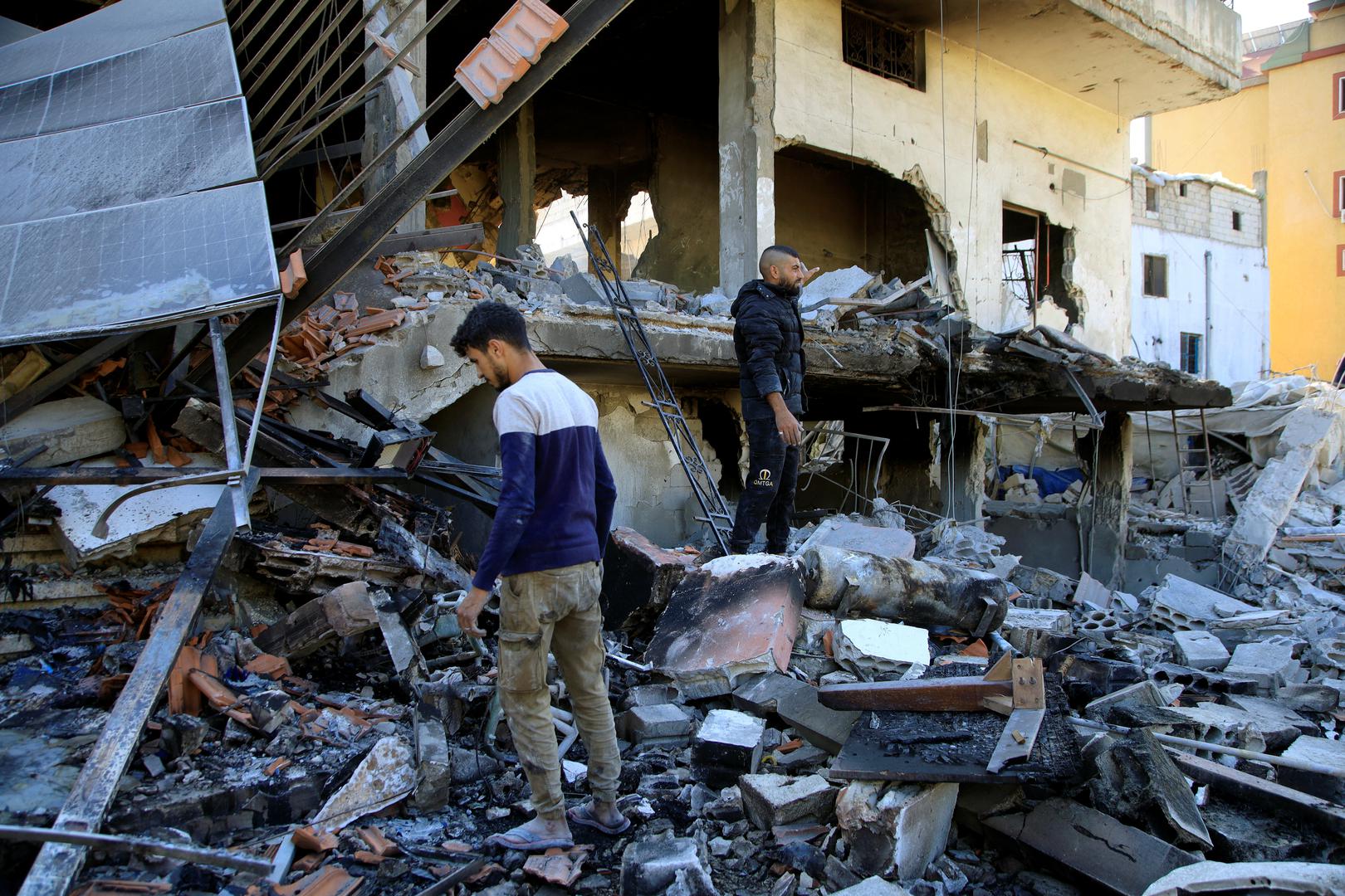 People stand on the rubble of a damaged building, in the Lebanese southern village of Akbiyeh, amid ongoing cross-border hostilities between Hezbollah and Israeli forces, Lebanon, September 24, 2024. REUTERS/Stringer Photo: STRINGER/REUTERS