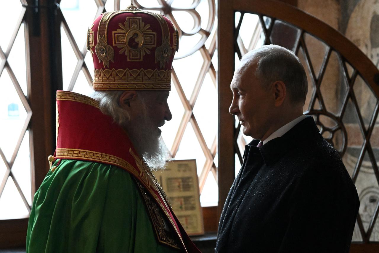 Russian President Vladimir Putin and Patriarch Kirill of Moscow and all Russia attend a prayer service following an inauguration ceremony at the Kremlin's Annunciation Cathedral in Moscow