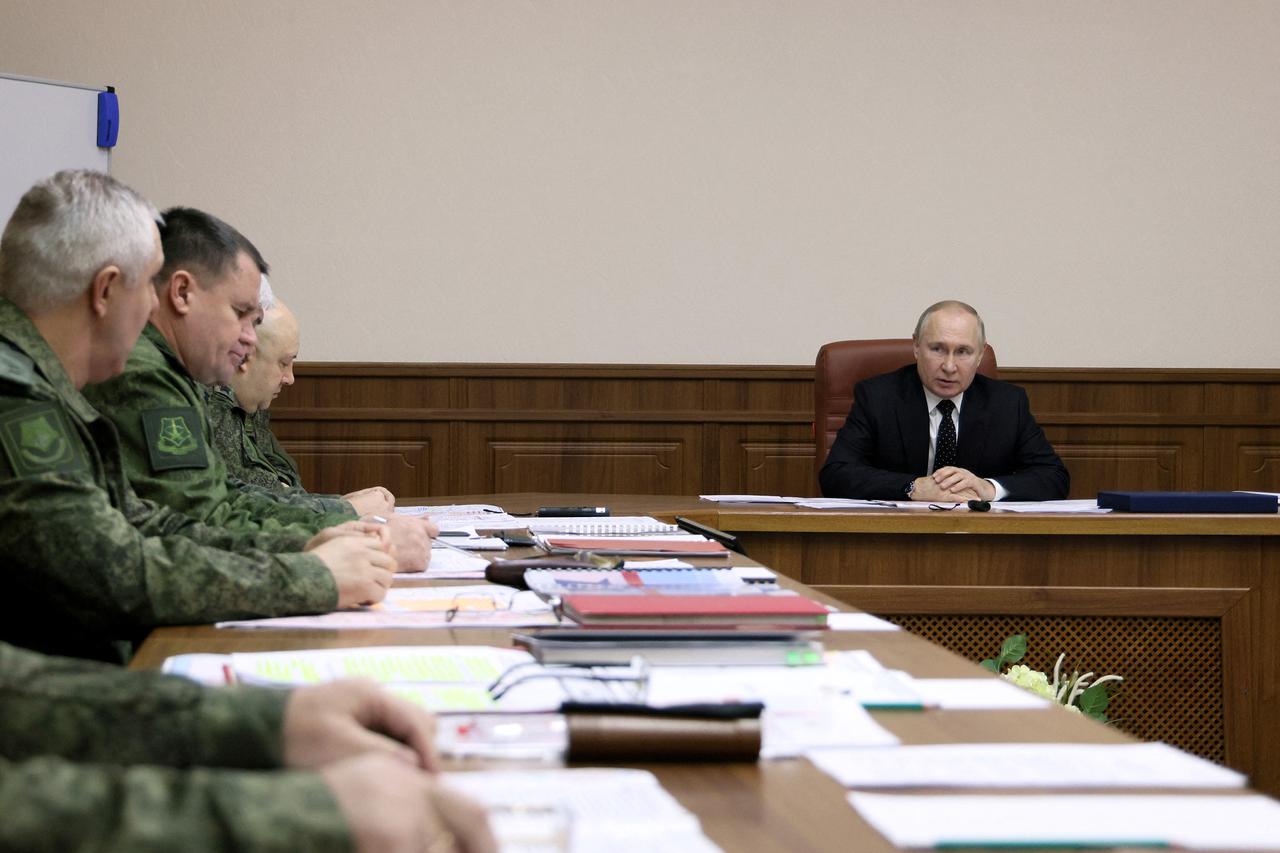 Russian President Vladimir Putin visits the Joint Headquarters of the Russian armed forces, in an unknown location