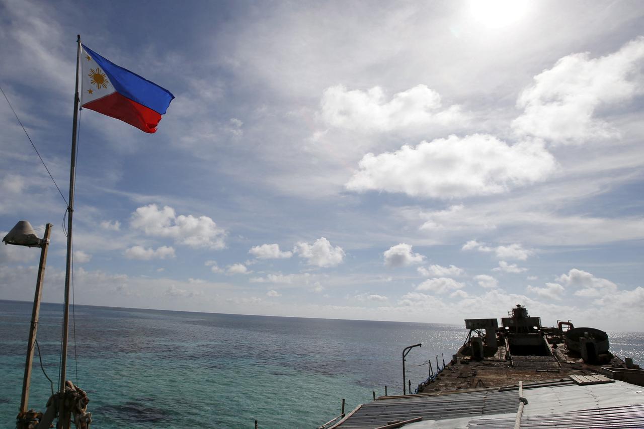 FILE PHOTO: A Philippine flutters on BRP Sierra Madre, a dilapidated Philippine Navy ship that has been aground since 1999, on the disputed Second Thomas Shoal, part of the Spratly Islands, in the South China Sea