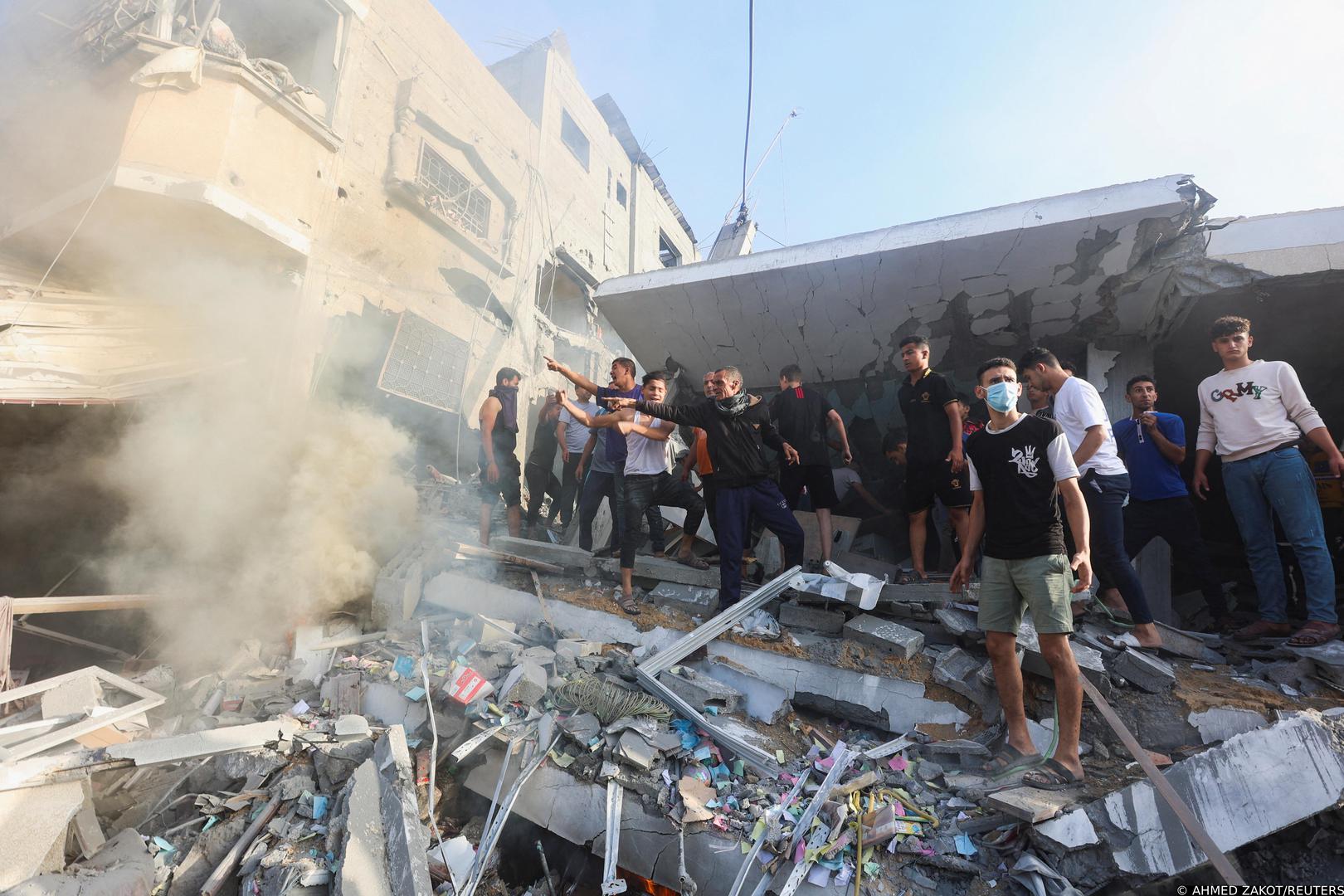 Palestinians stand on rubble as they react at the site of Israeli strikes on a residential building, amid the ongoing conflict between Israel and Palestinian Islamist group Hamas, in Khan Younis in the southern Gaza Strip, November 7, 2023. REUTERS/Ahmed Zakot Photo: AHMED ZAKOT/REUTERS