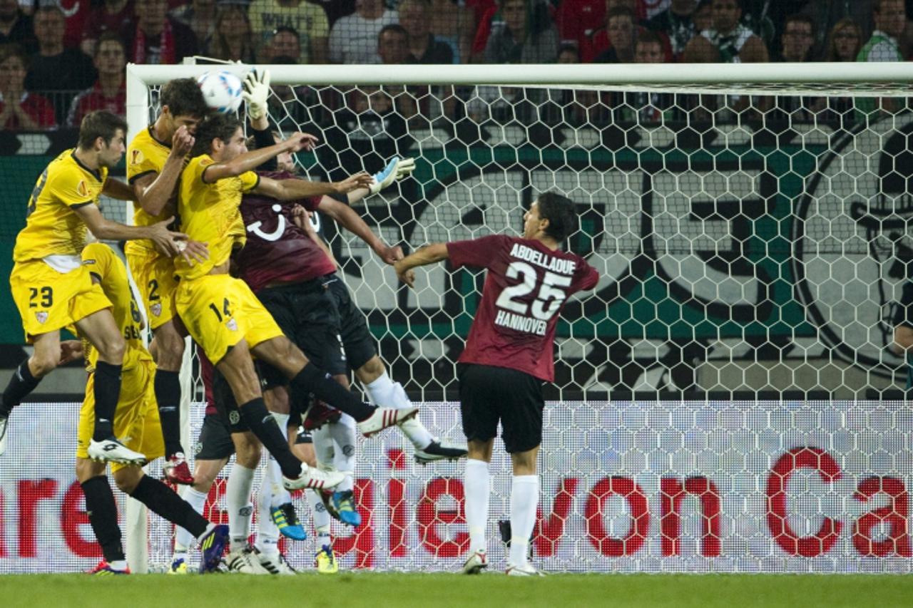 'Sevilla FC players try to score off a corner during the UEFA Europa League play off match Hanover 96 (Germany) vs FC Sevilla (Spain) in the northern German city of Hanover on August 18, 2011. Hanover