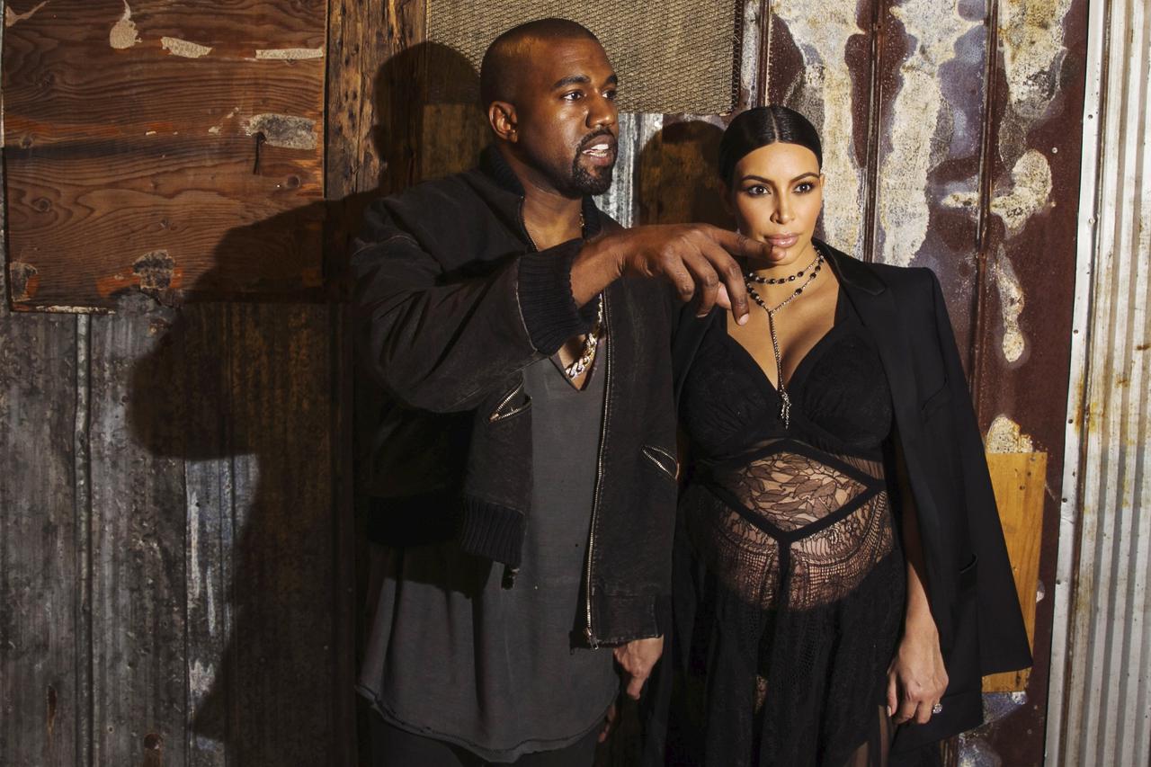 Musician Kanye West stands with his wife Kim Kardashian after watching the Givenchy Spring/Summer 2016 collection during New York Fashion Week in New York September 11, 2015.  REUTERS/Lucas Jackson