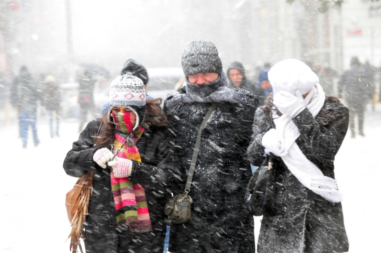 \'People walk under heavy snow on Istiklal Avenue in Istanbul on January 23, 2010. Heavy snow and high speed winds are affecting Istanbul, causing blackouts as well as related natural gas and water ou