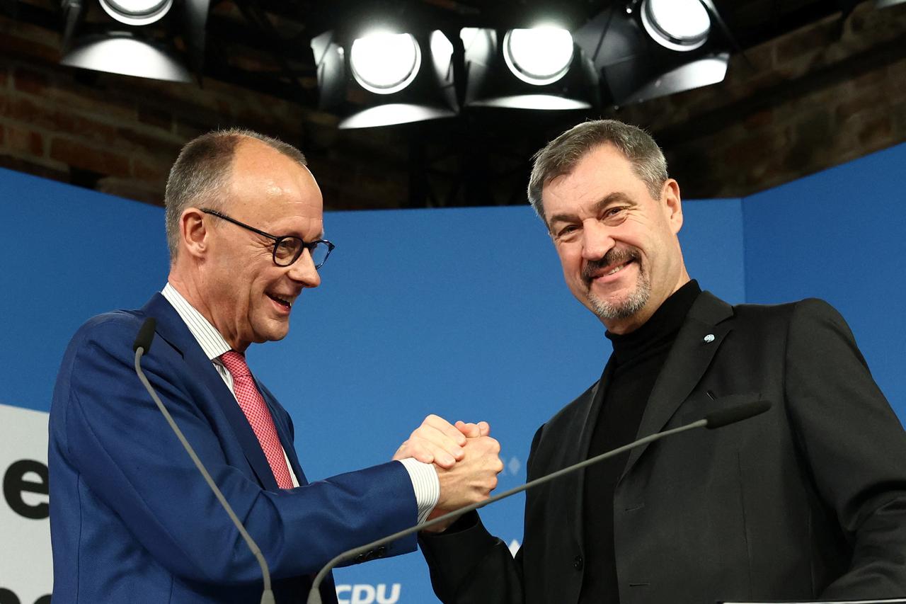 Bavarian State Prime Minister Markus Soeder of the Christian Social Union (CSU) and Christian Democratic Union (CDU) leader Friedrich Merz shake hands at a press conference on the day of a joint leadership meeting in Berlin