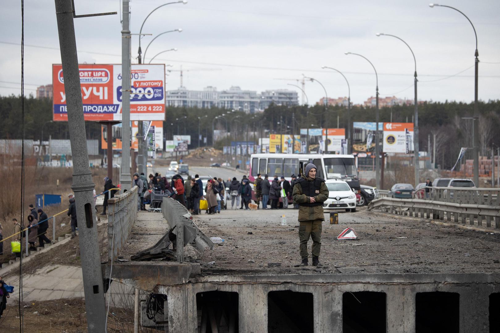 Soldiers help people cross a destroyed bridge as they evacuate the city of Irpin, northwest of Kyiv, during heavy shelling and bombing on March 5, 2022, 10 days after Russia launched a military invasion on Ukraine. Photo by Raphael Lafargue/ABACAPRESS.COM