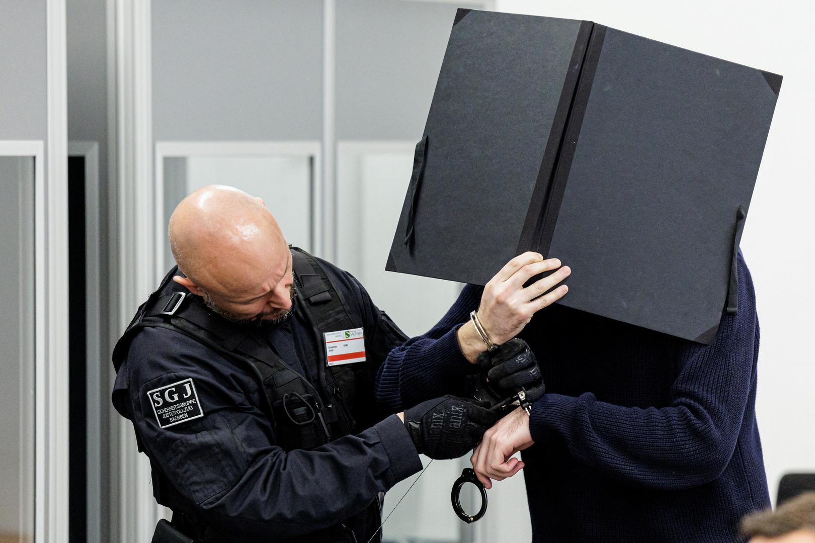 Defendant Wissam R. is led in handcuffs by judicial officers into the courtroom of the Higher Regional Court prior to a hearing in the trial over a November 2019 jewellery heist on the Green Vault (Gruenes Gewoelbe) museum in Dresden's Royal Palace, in Dresden, Germany, March 20, 2023. Jens Schlueter/Pool via REUTERS Photo: POOL/REUTERS