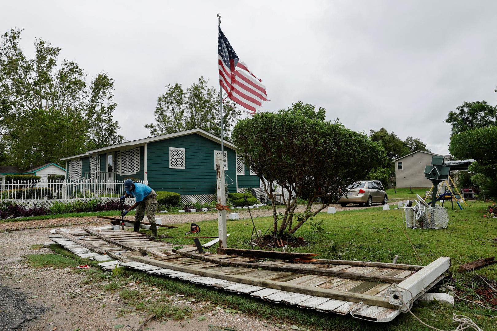 A person fixes a knocked-down fence in the aftermath of Hurricane Beryl, in Wharton, Texas, U.S., July 8, 2024. REUTERS/Daniel Becerril Photo: DANIEL BECERRIL/REUTERS