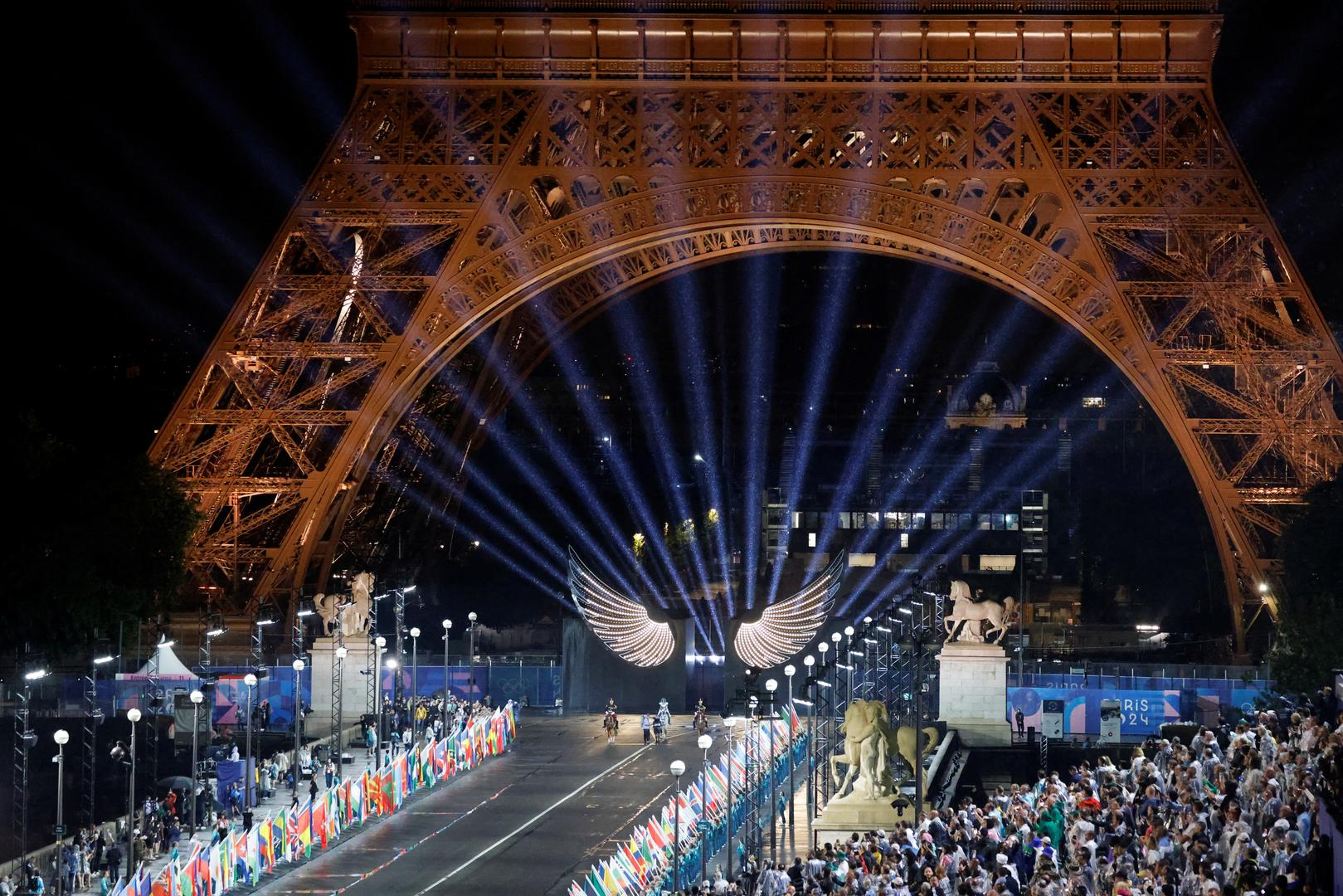 Paris 2024 Olympics - Opening Ceremony - Paris, France - July 26, 2024. Floriane Issert, a Gendarmerie non-commissioned officer of the National Gendarmerie, rides a horse while leading volunteers carrying flags of Olympic teams during the opening ceremony of the Paris 2024 Olympic Games.     LUDOVIC MARIN/Pool via REUTERS Photo: LUDOVIC MARIN/REUTERS