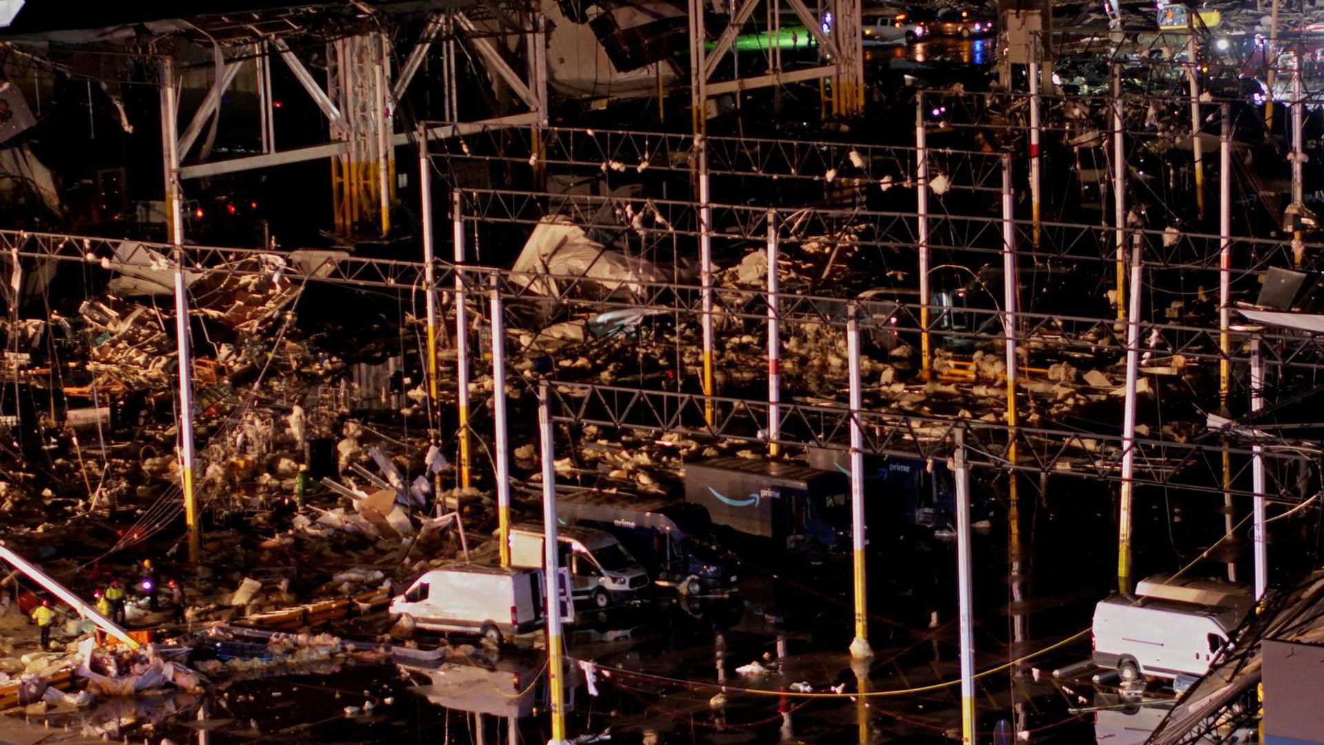 Debris lies around delivery vehicles at a collapsed Amazon.com warehouse after a tornado passed through Edwardsville, Illinois, U.S., December 10, 2021 in a still image taken from drone video obtained on December 11, 2021. Chris Phillips/Maverick Media Group, LLC via REUTERS  THIS IMAGE HAS BEEN SUPPLIED BY A THIRD PARTY. MANDATORY CREDIT