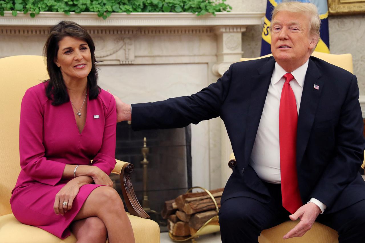 FILE PHOTO: U.S. President Trump reaches out to uutgoing U.S. Ambassador to the U.N. Haley as they meet in the Oval Office of the White House in Washington