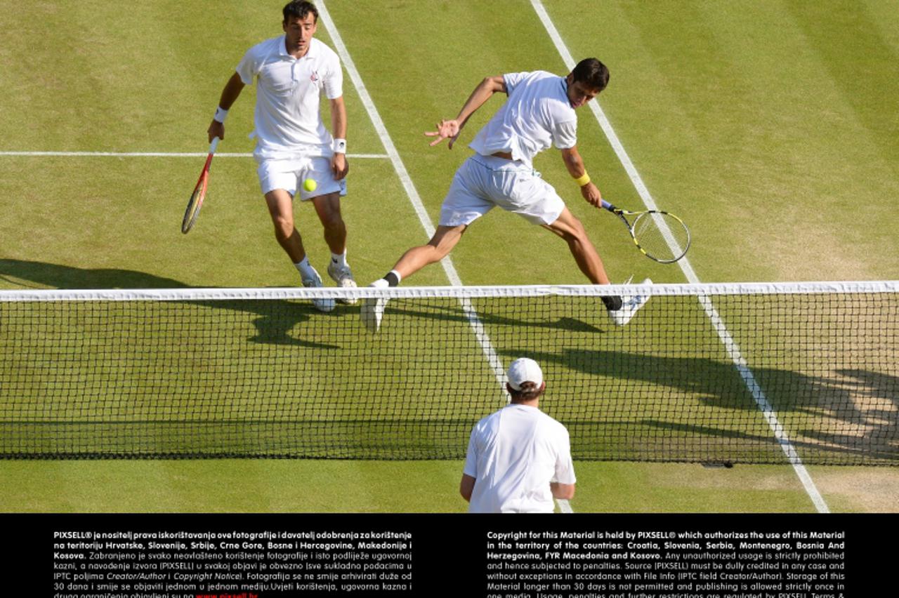 'Croatia\'s Ivan Dodig and Brazil\'s Marcelo Melo (right) in their Gentlemen\'s Doubles final against Bob and Mike Bryan during day twelve of the Wimbledon Championships at The All England Lawn Tennis
