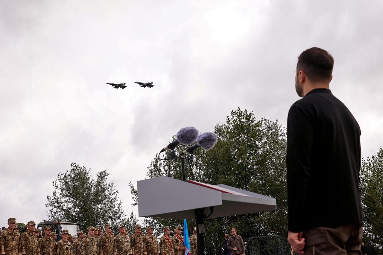 FILE PHOTO: Ukraine's President Zelenskiy looks at F-16 fighter aircraft on the Day of the Ukrainian Air Forces in an undisclosed location in Ukraine