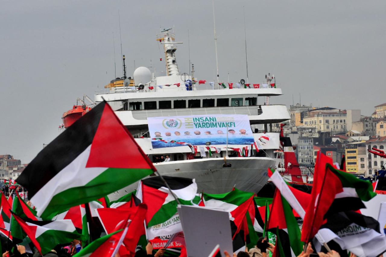 'Turkish ship Mavi Marmara arrives at Istanbul\'s Sarayburnu port as people wave Turkish and Palestinian flags on December 26, 2010. The Israeli navy raided on May 31, 2010 the Turkish ship Mavi Marma