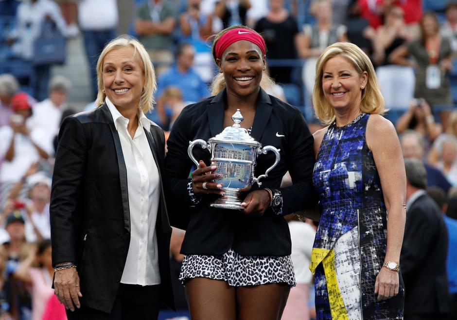 FILE PHOTO: Williams of the U.S. holds her trophy while flanked by tennis greats Navratilova and Evert after Williams defeated Wozniacki of Denmark in their women's singles finals match at the 2014 U.S. Open tennis tournament in New York