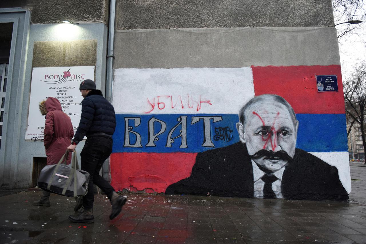 A mural of Russian President Vladimir Putin is vandalised, in Belgrade