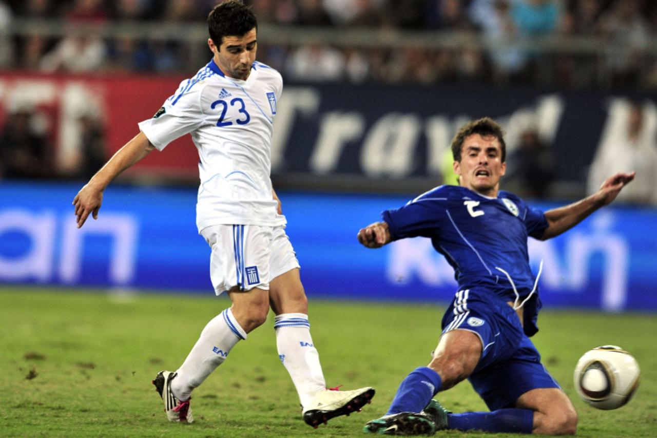 \'Greece\'s Giannis Fetfatzidis (L) shoots the ball next to Israeli Dani Bondaru during their group F Euro 2012 qualification football game against Greece at the Karaiskaki stadium in Athens on Octobe